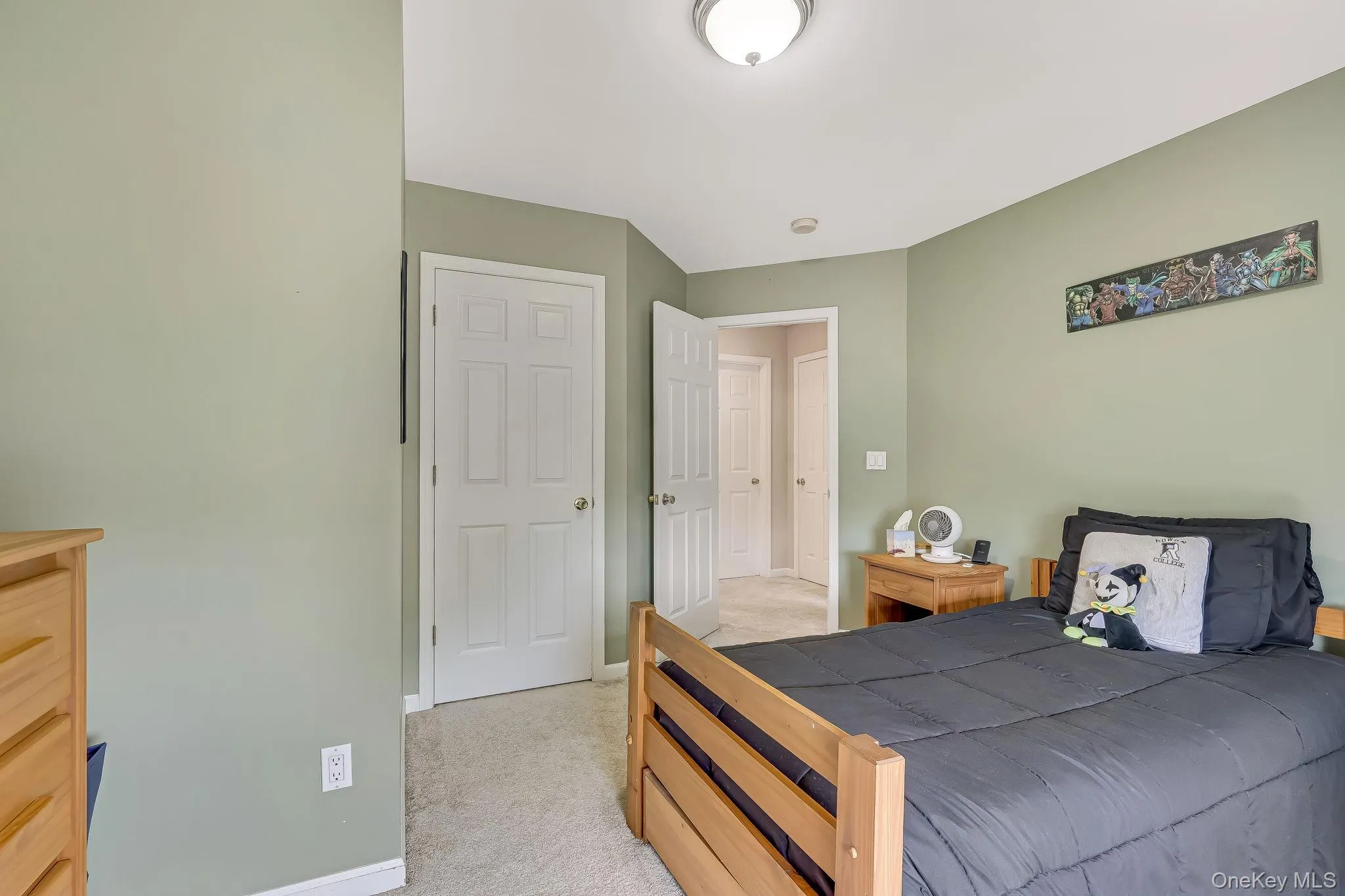 Carpeted room with light green walls and white trim Carpeted room with light green walls and white trim