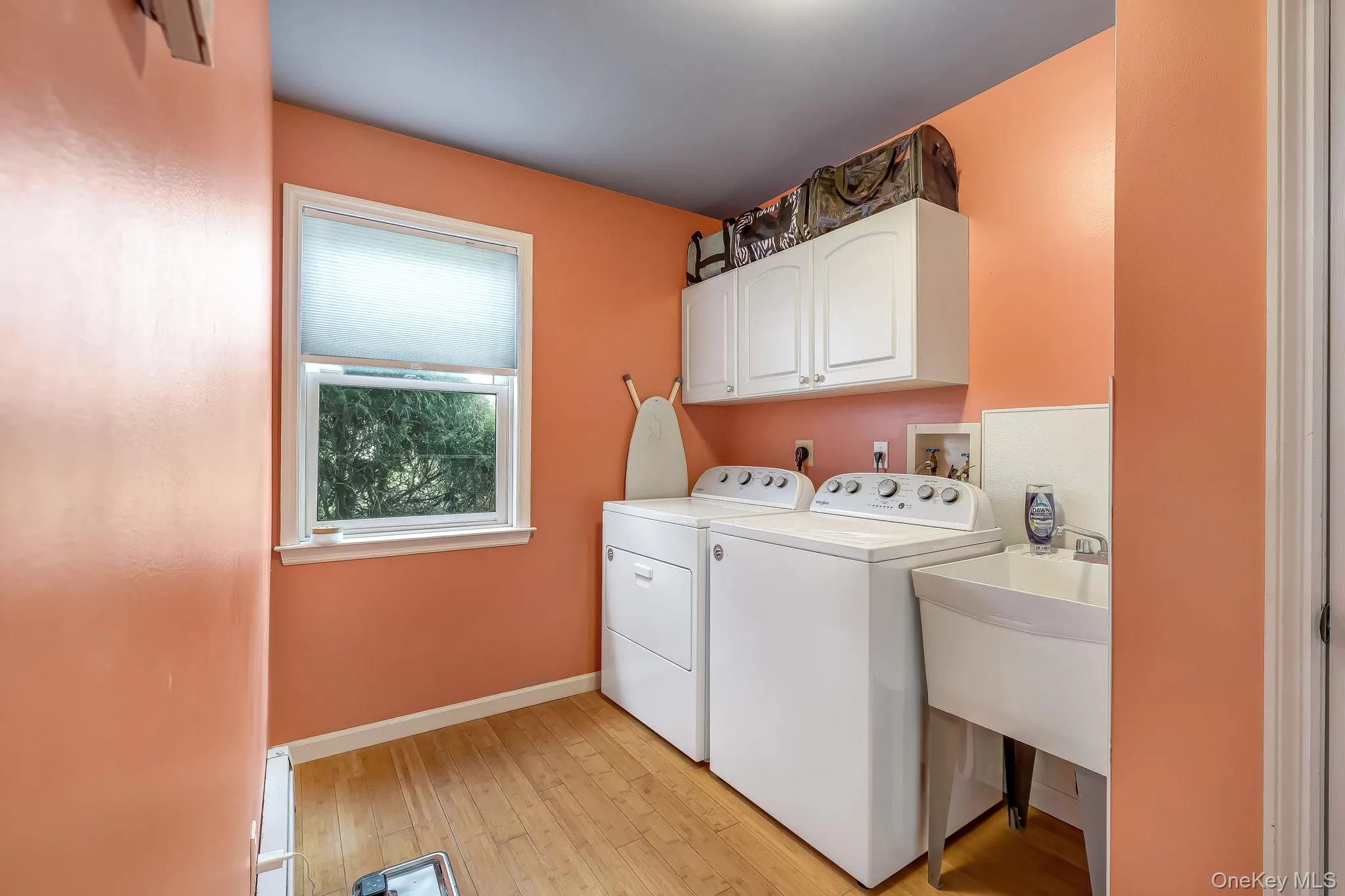 First floor laundry room with a utility sink. First floor laundry room with a utility sink.