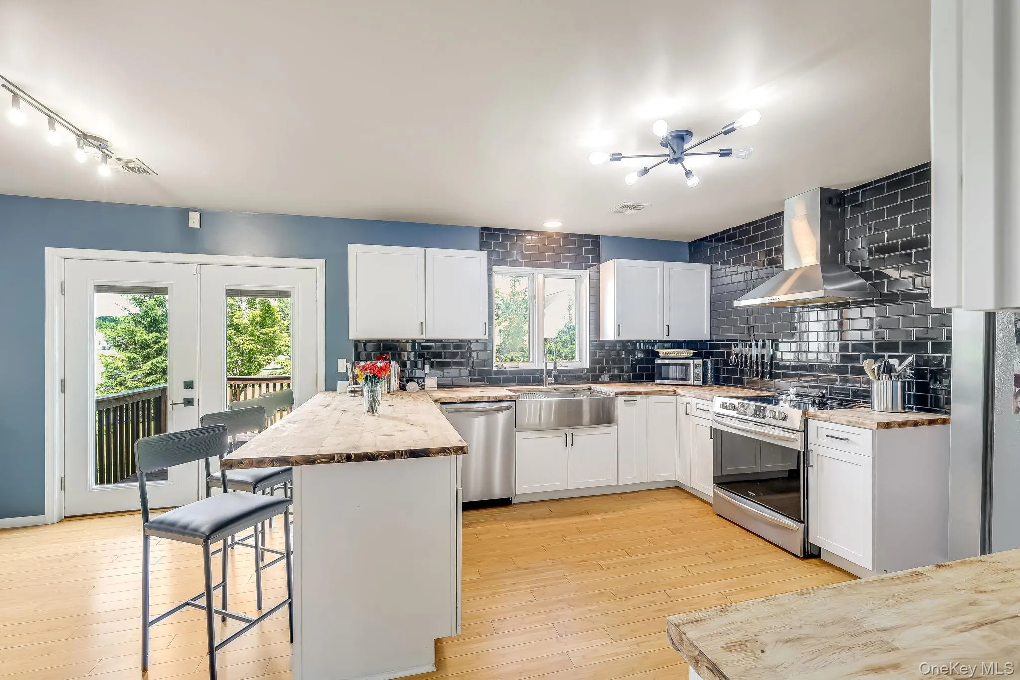 Contemporary kitchen featuring stainless steel appliances, and a window over the farmhouse sink. Contemporary kitchen featuring stainless steel appliances, and a window over the farmhouse sink.