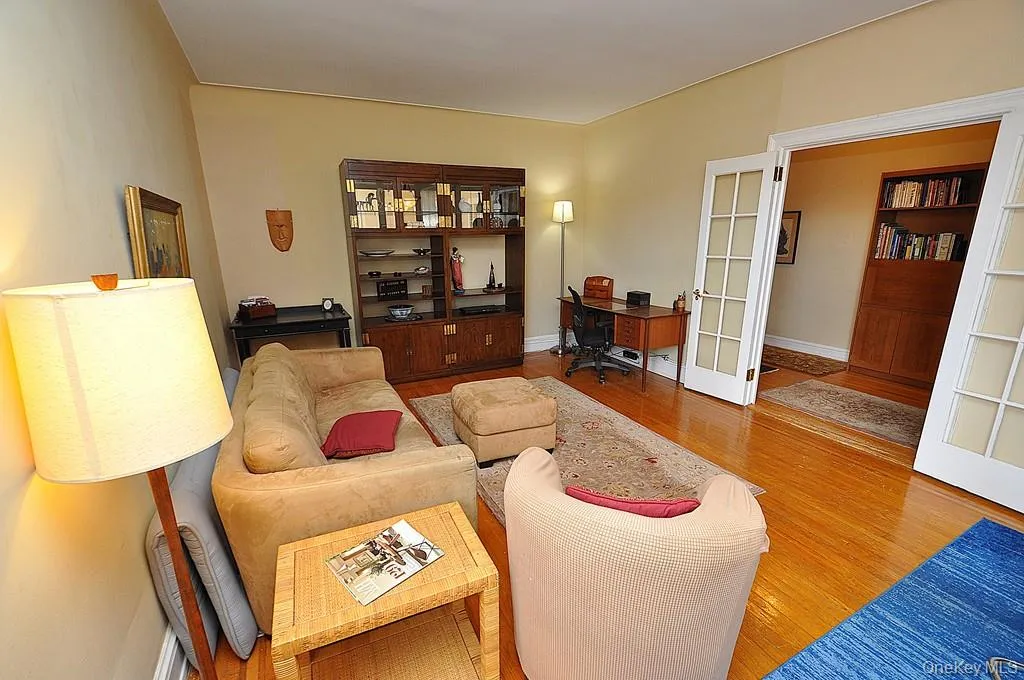 The large living room can accommodate both an entertaining and dining area. There are French doors to create privacy from the foyer. The room has hardwood floors and is approx. 12'-9" x 21'-0" The large living room can accommodate both an entertaining and dining area. There are French doors to create privacy from the foyer. The room has hardwood floors and is approx. 12'-9" x 21'-0"
