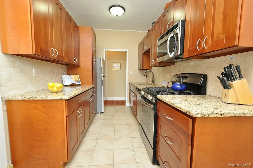 Renovated Eat-in-Kitchen has Granite Counters, Stainless Steel Appliances, Cherry Cabinets and a window for ventilation and natural light. Renovated Eat-in-Kitchen has Granite Counters, Stainless Steel Appliances, Cherry Cabinets and a window for ventilation and natural light.