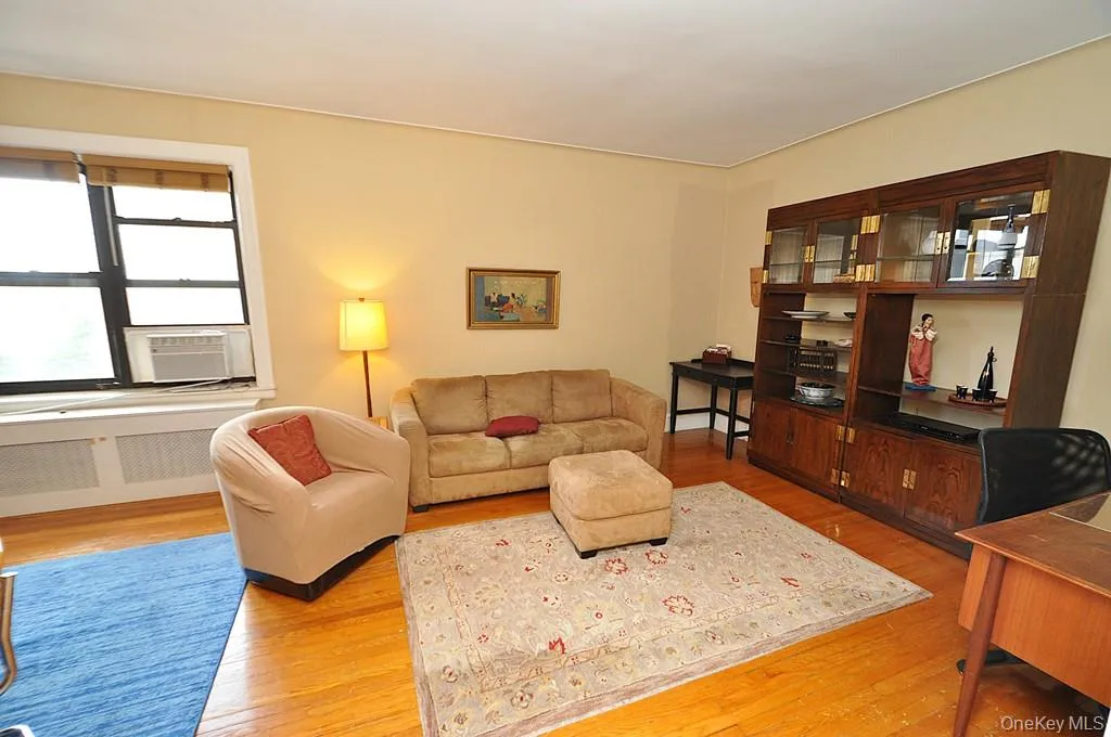 The large living room can accommodate both an entertaining and dining area. There are French doors to create privacy from the foyer. The room has hardwood floors and is approx. 12'-9" x 21'-0" The large living room can accommodate both an entertaining and dining area. There are French doors to create privacy from the foyer. The room has hardwood floors and is approx. 12'-9" x 21'-0"