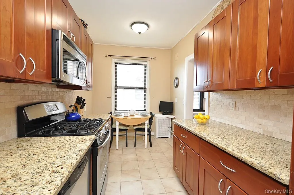 Renovated Eat-in-Kitchen has Granite Counters, Stainless Steel Appliances, Cherry Cabinets and a window for ventilation and natural light. Renovated Eat-in-Kitchen has Granite Counters, Stainless Steel Appliances, Cherry Cabinets and a window for ventilation and natural light.