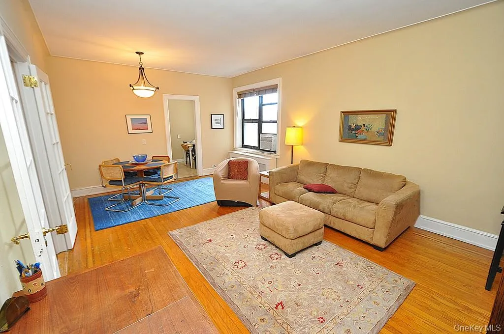 The large living room can accommodate both an entertaining and dining area. There are French doors to create privacy from the foyer. The room has hardwood floors and is approx. 12'-9" x 21'-0" The large living room can accommodate both an entertaining and dining area. There are French doors to create privacy from the foyer. The room has hardwood floors and is approx. 12'-9" x 21'-0"