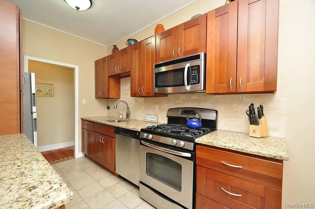 Renovated Eat-in-Kitchen has Granite Counters, Stainless Steel Appliances, Cherry Cabinets and a window for ventilation and natural light. Renovated Eat-in-Kitchen has Granite Counters, Stainless Steel Appliances, Cherry Cabinets and a window for ventilation and natural light.