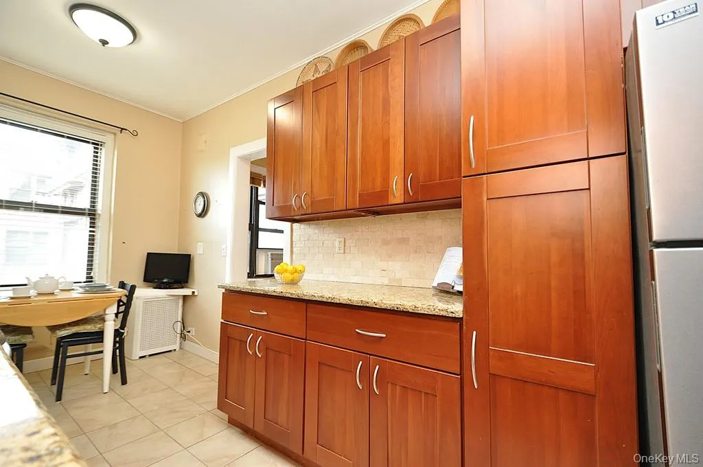 Renovated Eat-in-Kitchen has Granite Counters, Stainless Steel Appliances, Cherry Cabinets and a window for ventilation and natural light. Renovated Eat-in-Kitchen has Granite Counters, Stainless Steel Appliances, Cherry Cabinets and a window for ventilation and natural light.