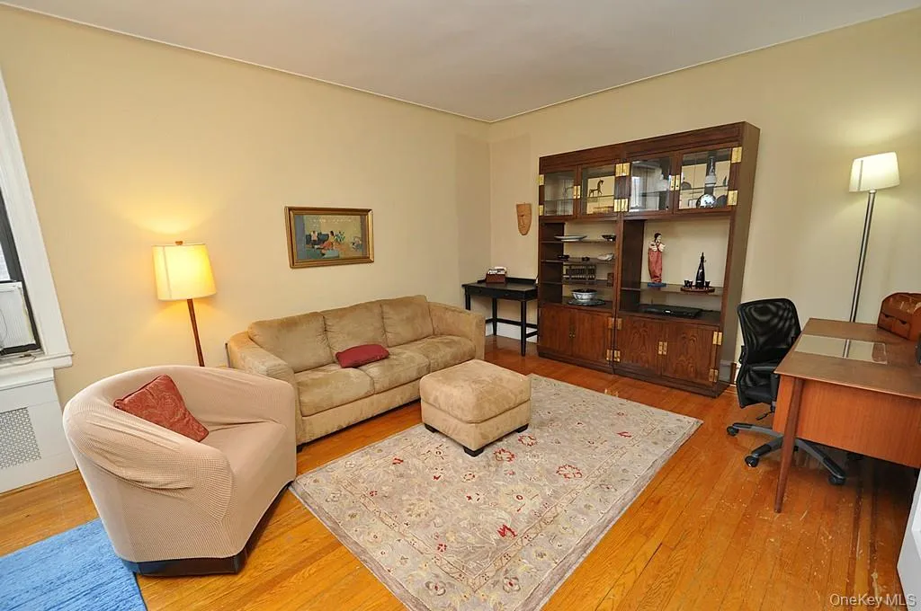 The large living room can accommodate both an entertaining and dining area. There are French doors to create privacy from the foyer. The room has hardwood floors and is approx. 12'-9" x 21'-0" The large living room can accommodate both an entertaining and dining area. There are French doors to create privacy from the foyer. The room has hardwood floors and is approx. 12'-9" x 21'-0"