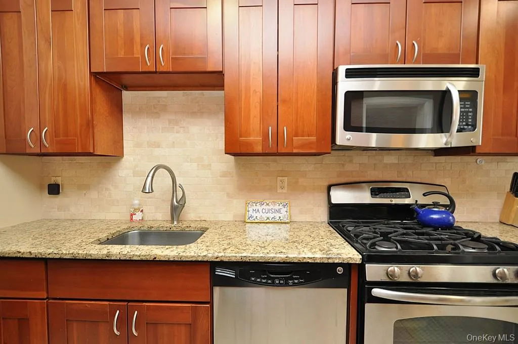 Renovated Eat-in-Kitchen has Granite Counters, Stainless Steel Appliances, Cherry Cabinets and a window for ventilation and natural light. Renovated Eat-in-Kitchen has Granite Counters, Stainless Steel Appliances, Cherry Cabinets and a window for ventilation and natural light.