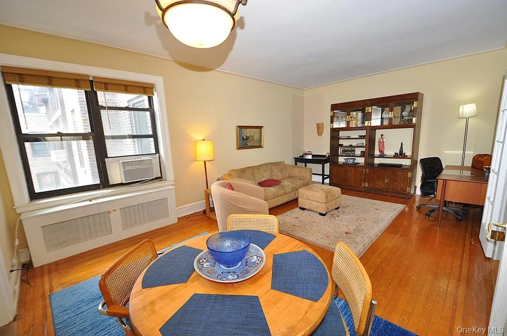 The large living room can accommodate both an entertaining and dining area. There are French doors to create privacy from the foyer. The room has hardwood floors and is approx. 12'-9" x 21'-0" The large living room can accommodate both an entertaining and dining area. There are French doors to create privacy from the foyer. The room has hardwood floors and is approx. 12'-9" x 21'-0"