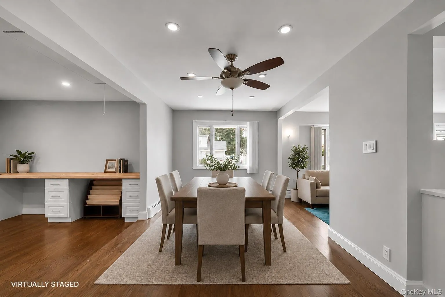 Open-concept dining area featuring wood-finish flooring, recessed lighting, and a ceiling fan Open-concept dining area featuring wood-finish flooring, recessed lighting, and a ceiling fan