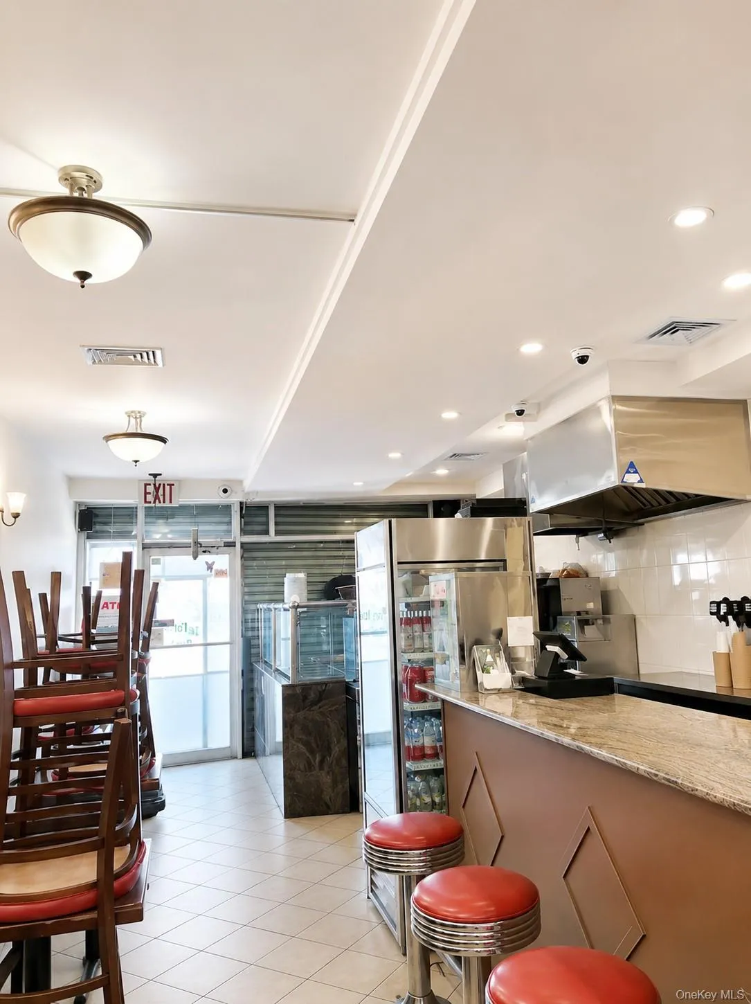 View of the entrance inside with chairs and stools View of the entrance inside with chairs and stools