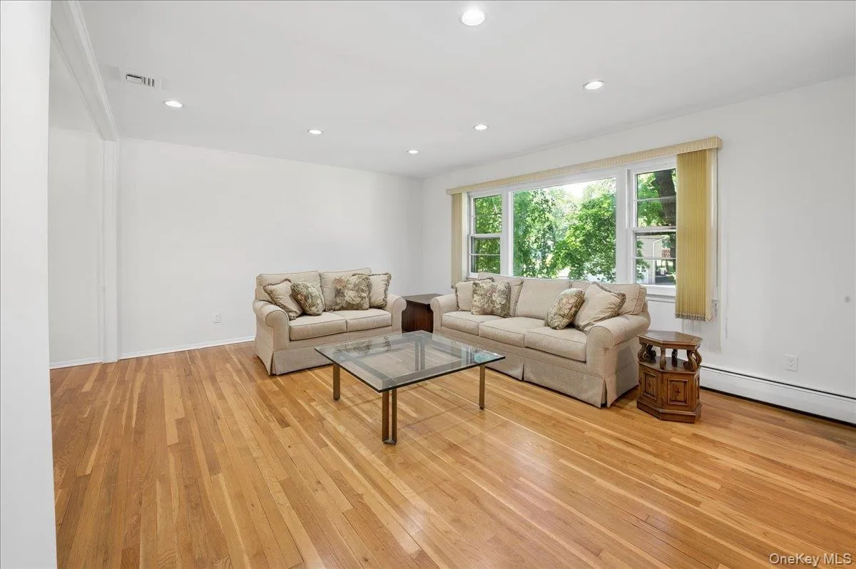 Light, bright, living room with large picture window and gleaming hardwood floors. Light, bright, living room with large picture window and gleaming hardwood floors.