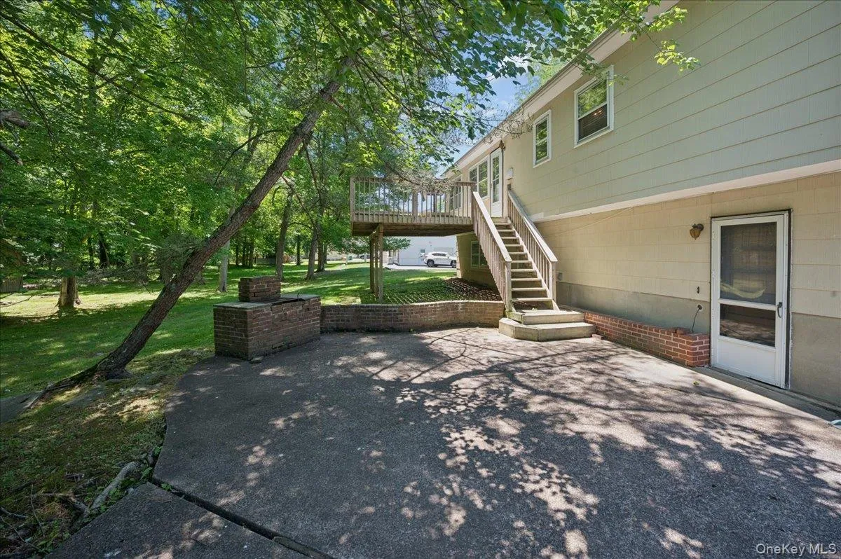 Backyard patio with deck access. Backyard patio with deck access.