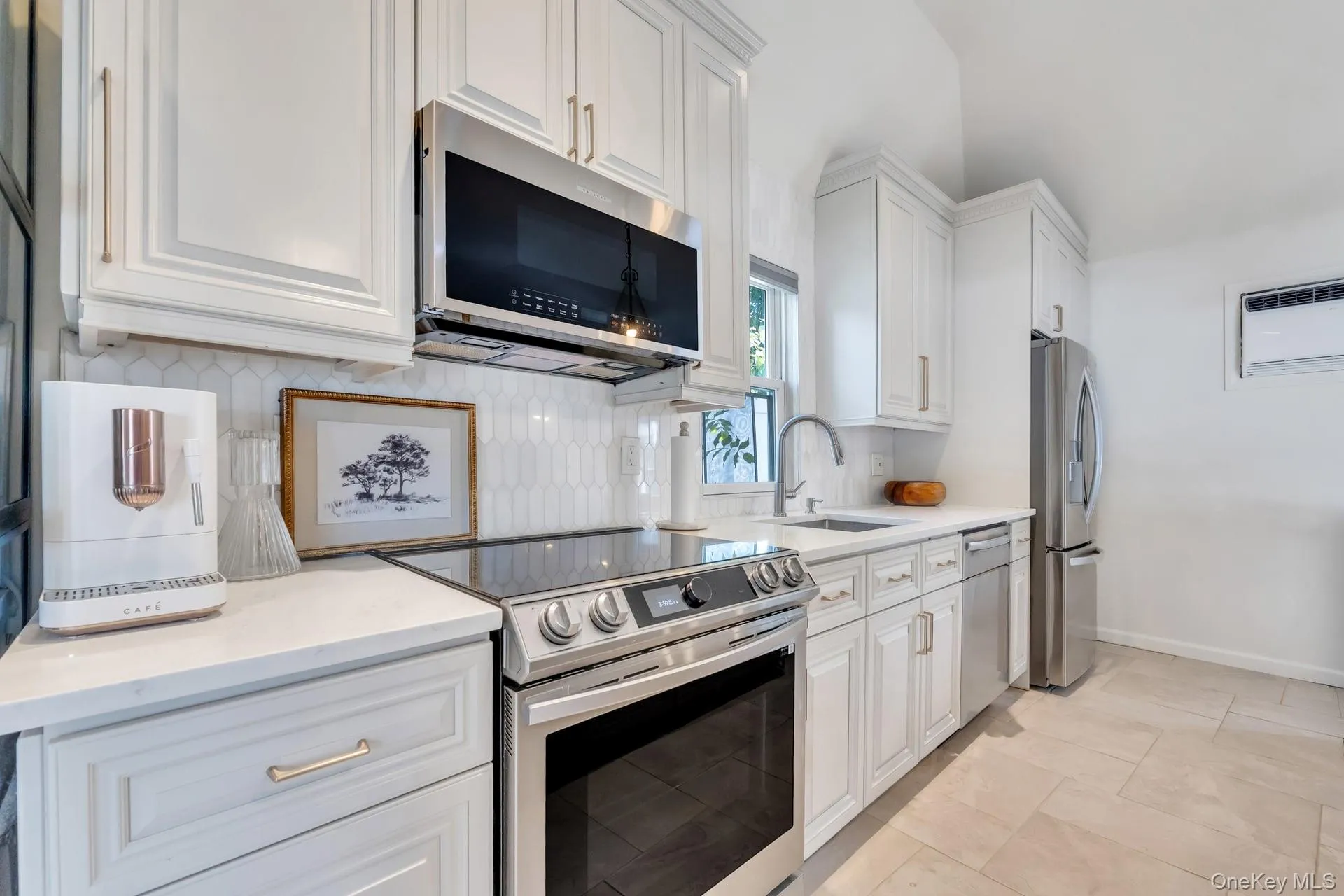 Modern kitchen featuring white shaker cabinetry, stainless steel appliances, a white subway tile backsplash, and a ceramic tile floor Modern kitchen featuring white shaker cabinetry, stainless steel appliances, a white subway tile backsplash, and a ceramic tile floor
