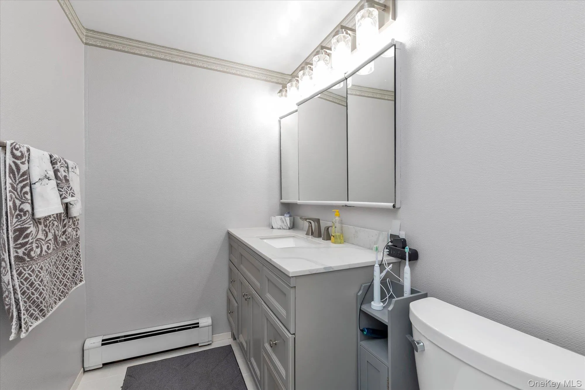 3rd Bathroom featuring a new vanity, with brushed nickel faucet, mirror-front medicine cabinet, and new vanity fixture. 3rd Bathroom featuring a new vanity, with brushed nickel faucet, mirror-front medicine cabinet, and new vanity fixture.