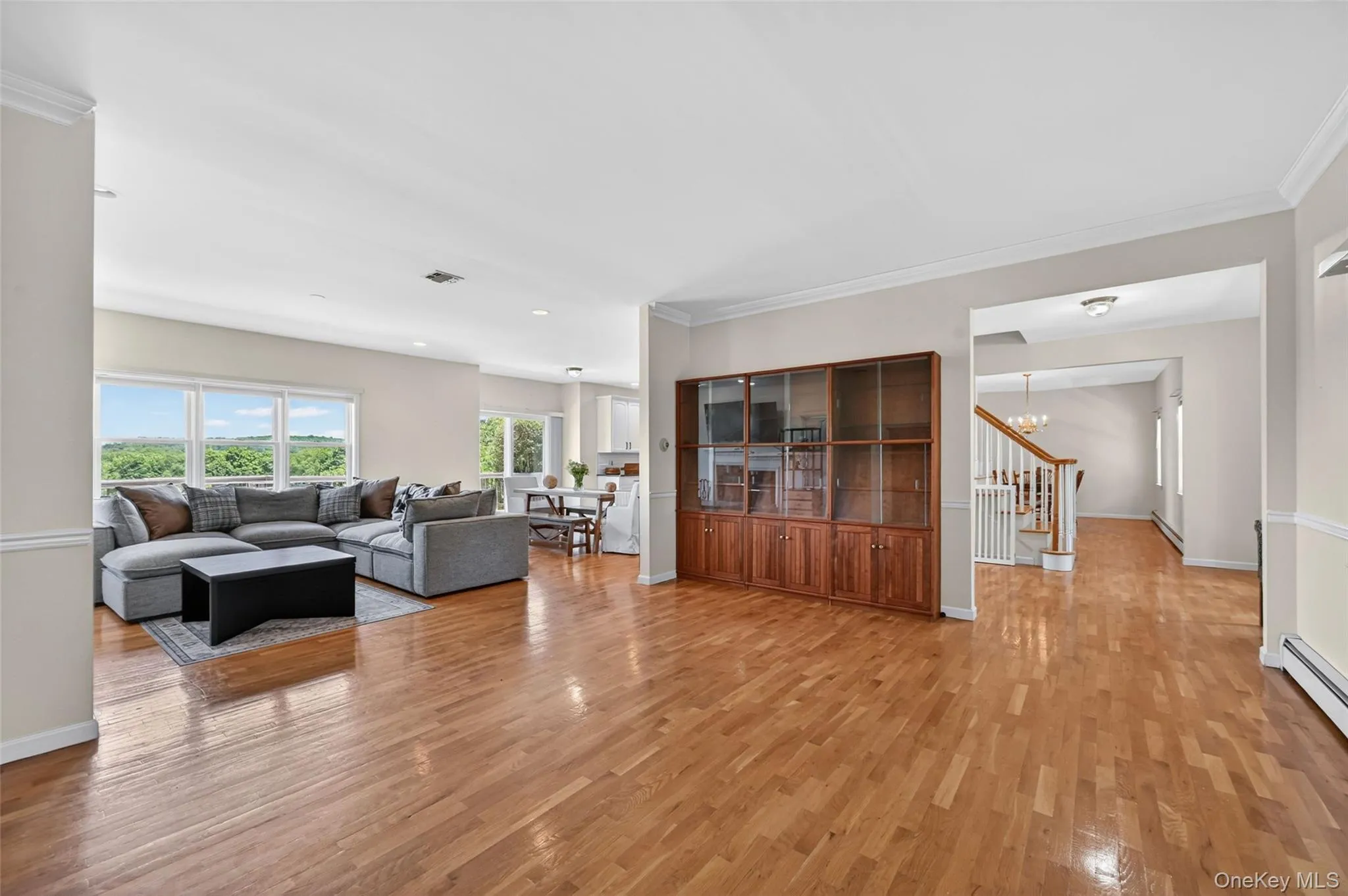 Expansive main living area featuring wood-finish flooring Expansive main living area featuring wood-finish flooring