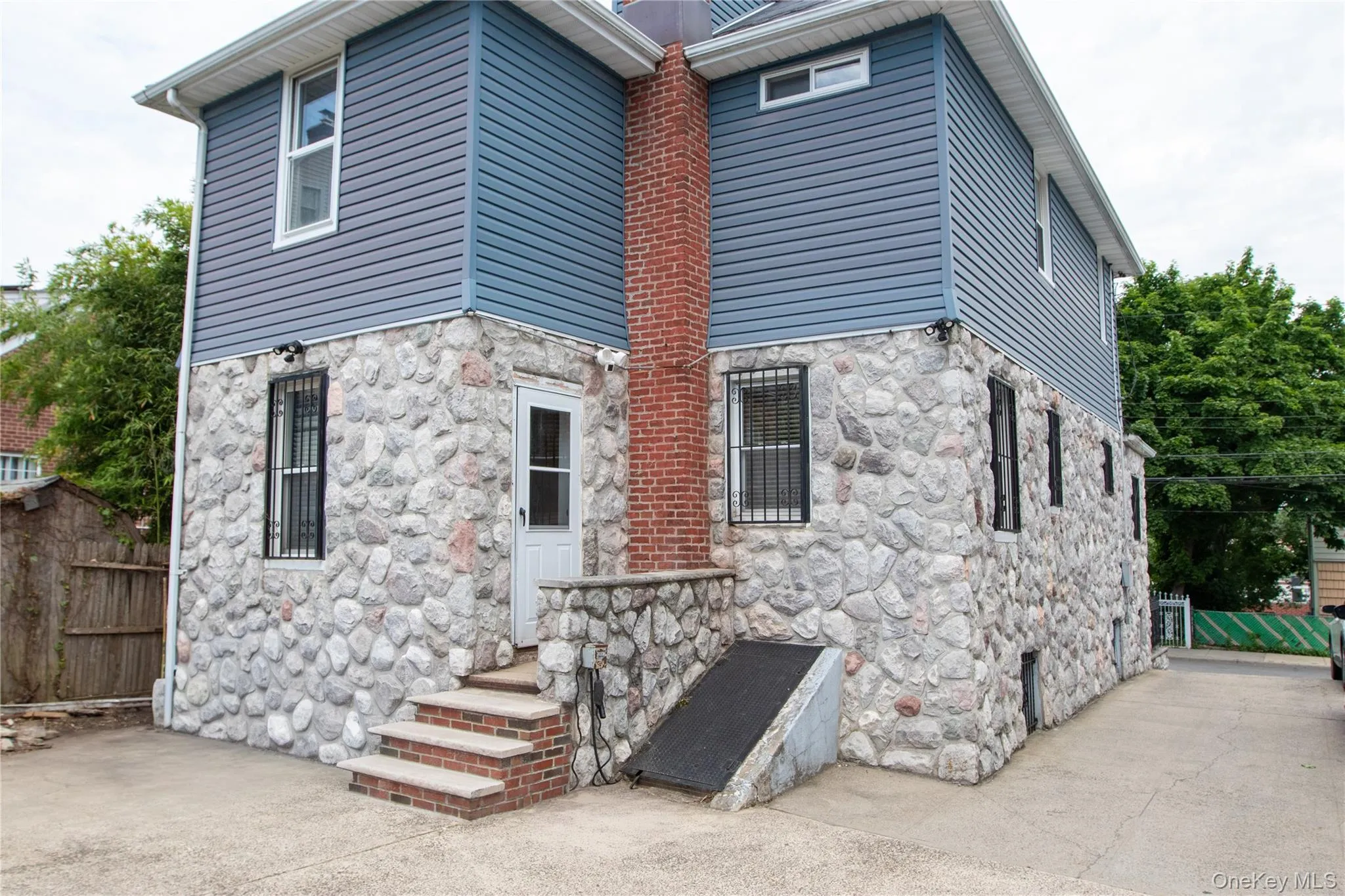 Exterior stone facade with complementary blue siding Exterior stone facade with complementary blue siding