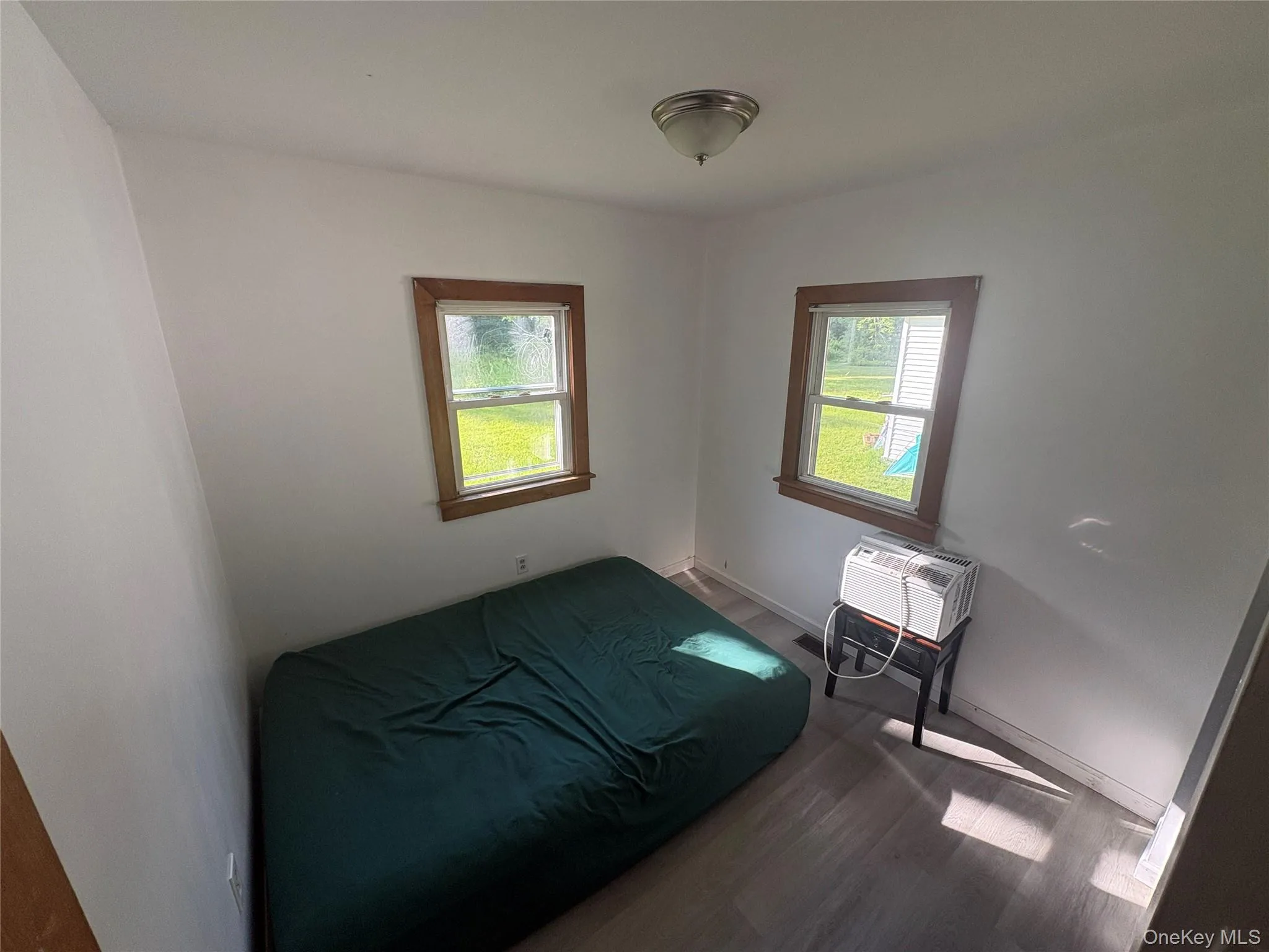 Bright bedroom with windows overlooking the property. Bright bedroom with windows overlooking the property.