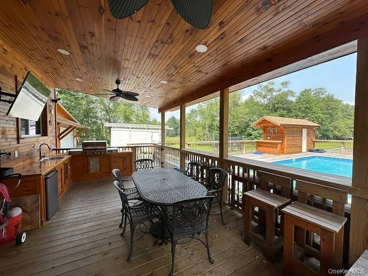 Outdoor seating area along with covered outdoor kitchen. Outdoor seating area along with covered outdoor kitchen.