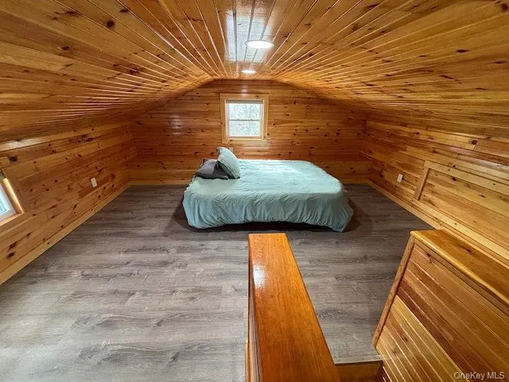 Spacious room featuring extensive pine throughout, wood-finish rectangular windows, and a built-in storage. Spacious room featuring extensive pine throughout, wood-finish rectangular windows, and a built-in storage.