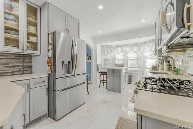 Contemporary kitchen featuring recessed lighting and light-colored cabinetry Contemporary kitchen featuring recessed lighting and light-colored cabinetry
