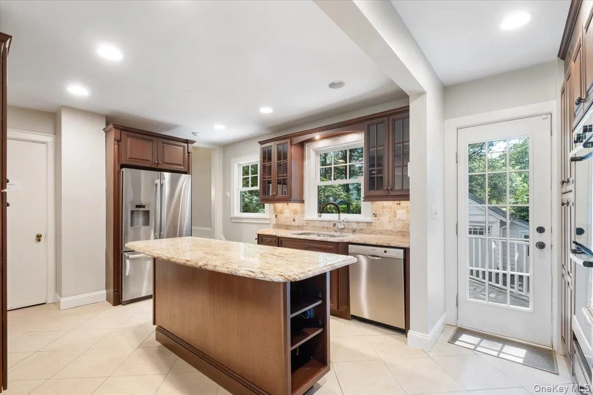 Eat in kitchen with island, stainless steel appliances and door to the deck Eat in kitchen with island, stainless steel appliances and door to the deck