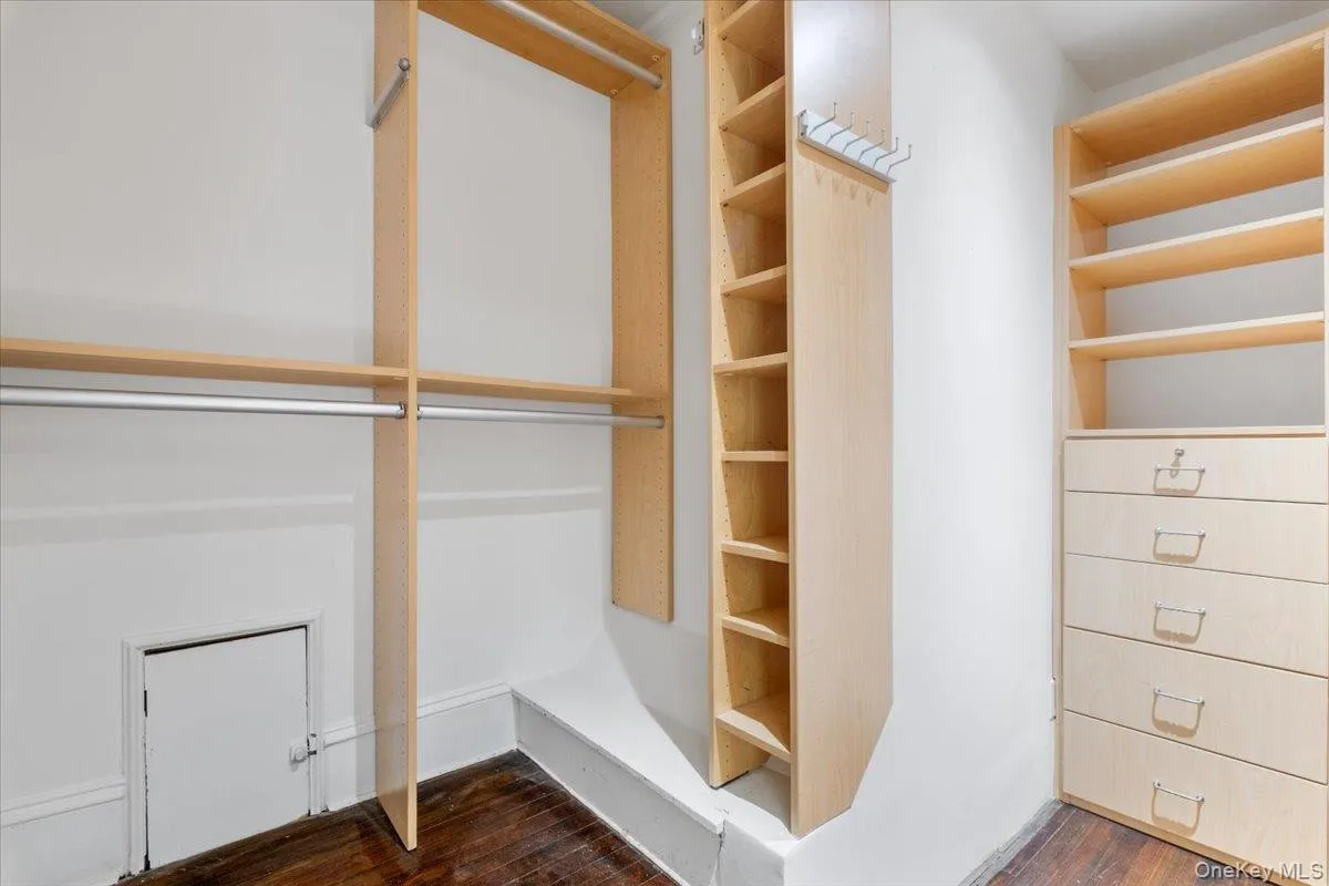 Primary bedroom walk in closet with shelves Primary bedroom walk in closet with shelves
