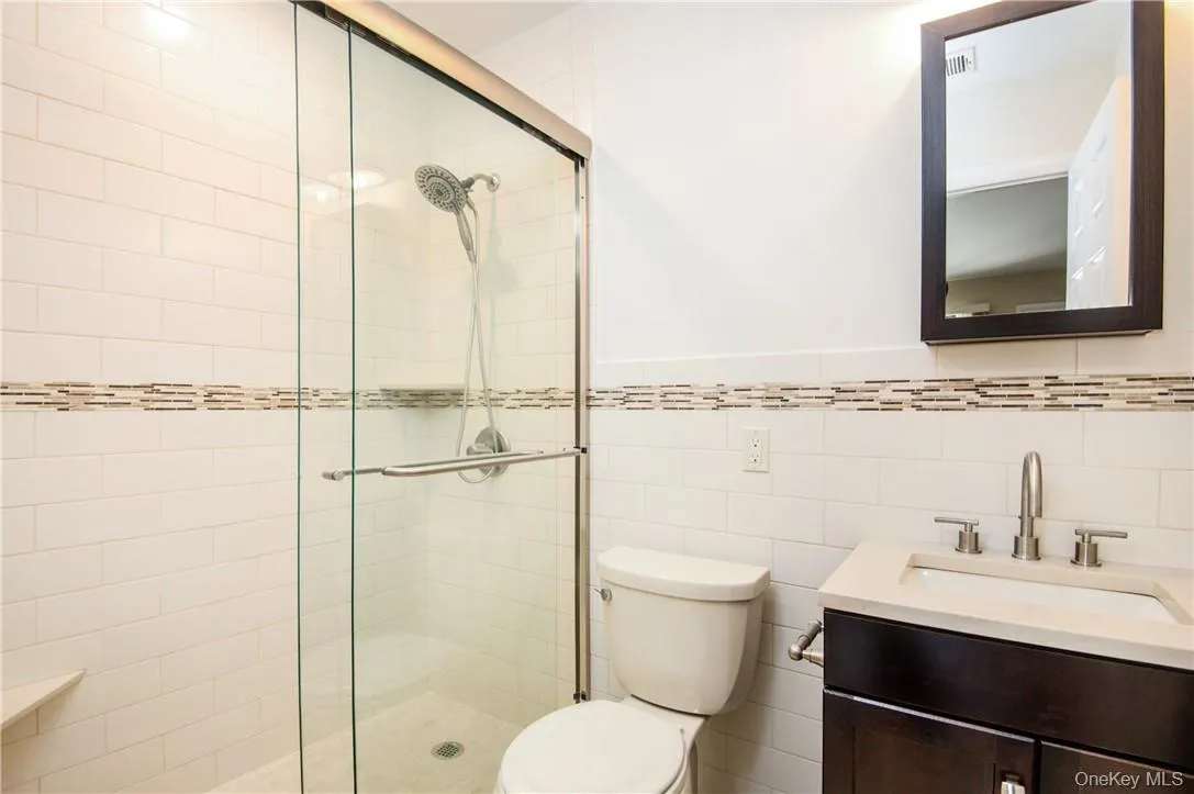 En-suite Master bathroom with beautiful tiles and dark wood cabinetry. En-suite Master bathroom with beautiful tiles and dark wood cabinetry.