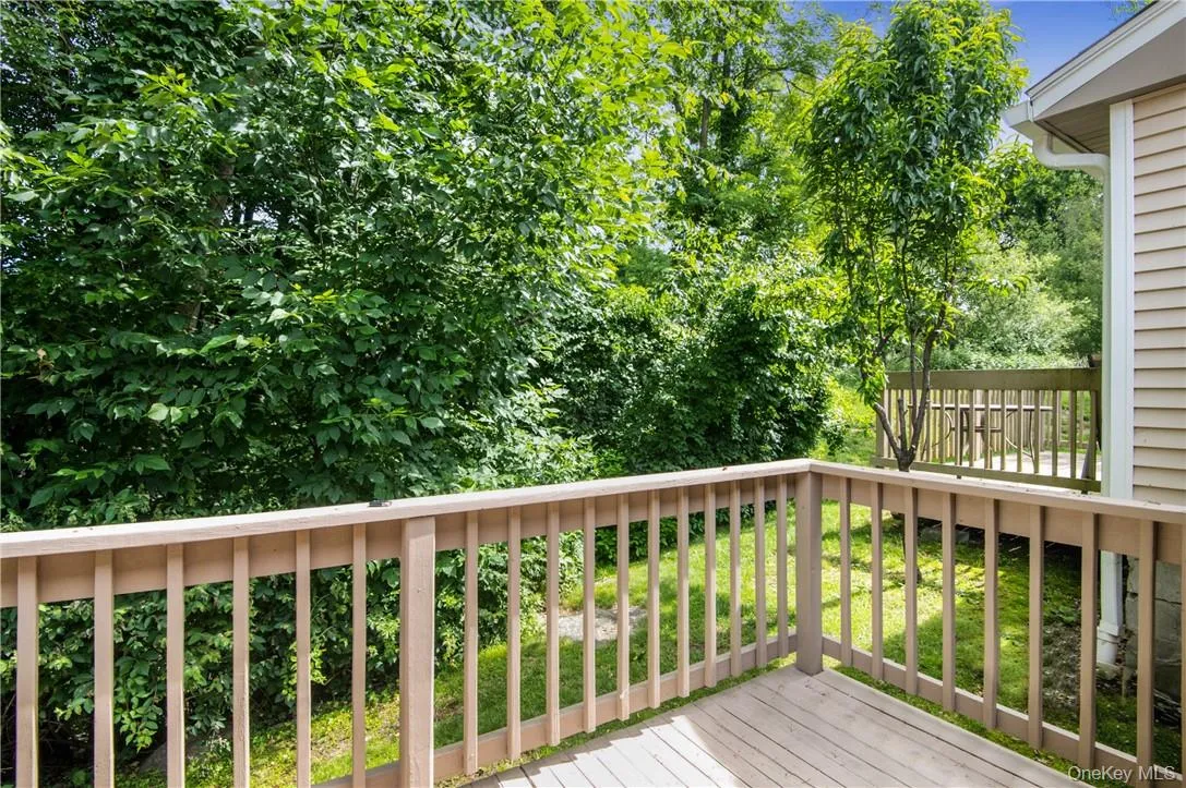 Deck off the living room backed by woods and babbling brook. Deck off the living room backed by woods and babbling brook.