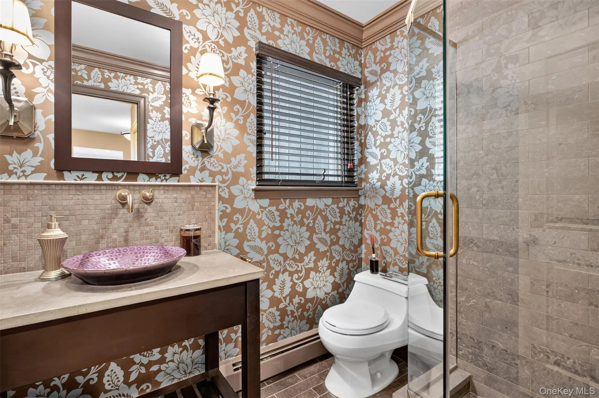 Adjacent to the first-floor bedroom, the elegant hall bath is ideal for guests and overnight visitors. Thoughtfully appointed with a marble vanity, vessel sink, and glass-enclosed shower, it offers both style and convenience. Adjacent to the first-floor bedroom, the elegant hall bath is ideal for guests and overnight visitors. Thoughtfully appointed with a marble vanity, vessel sink, and glass-enclosed shower, it offers both style and convenience.