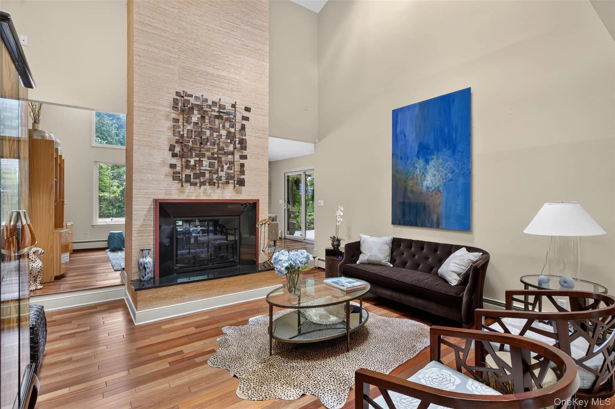 Serving as the architectural centerpiece of the home, a spectacular floor-to-ceiling double-sided wood-burning fireplace creates a dramatic focal point and enhances the flow between the formal living room and family room. Serving as the architectural centerpiece of the home, a spectacular floor-to-ceiling double-sided wood-burning fireplace creates a dramatic focal point and enhances the flow between the formal living room and family room.