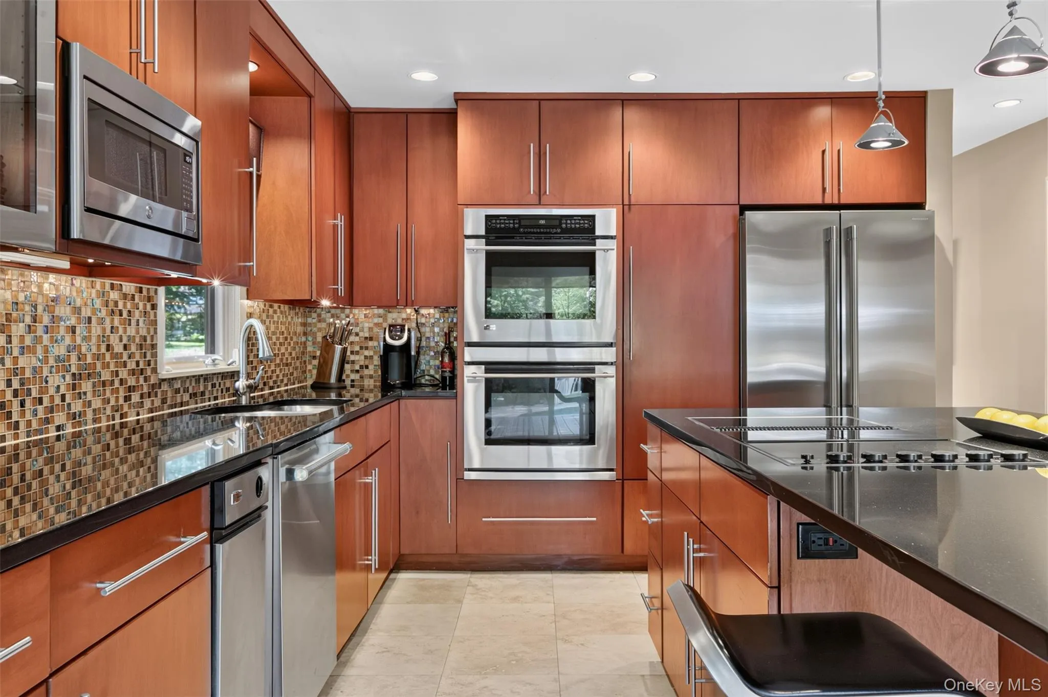 Designed for the serious home chef and avid entertainer alike, the kitchen features premium GE Monogram stainless steel appliances, including double convection ovens, making holiday gatherings and dinner parties effortless. Designed for the serious home chef and avid entertainer alike, the kitchen features premium GE Monogram stainless steel appliances, including double convection ovens, making holiday gatherings and dinner parties effortless.