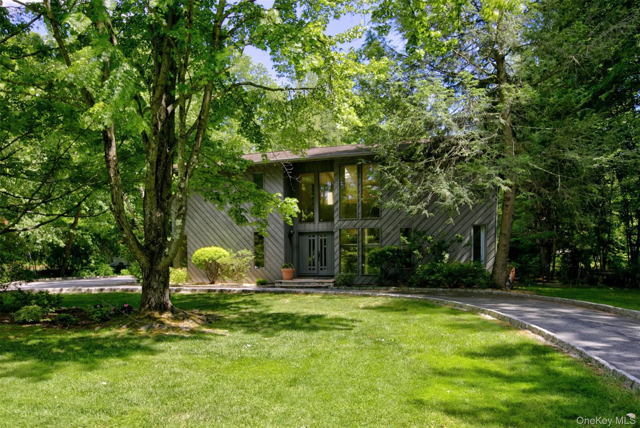A circular driveway provides a welcoming approach and ample guest parking, while the attached two-car garage offers convenience, storage, and easy access to the home. A circular driveway provides a welcoming approach and ample guest parking, while the attached two-car garage offers convenience, storage, and easy access to the home.
