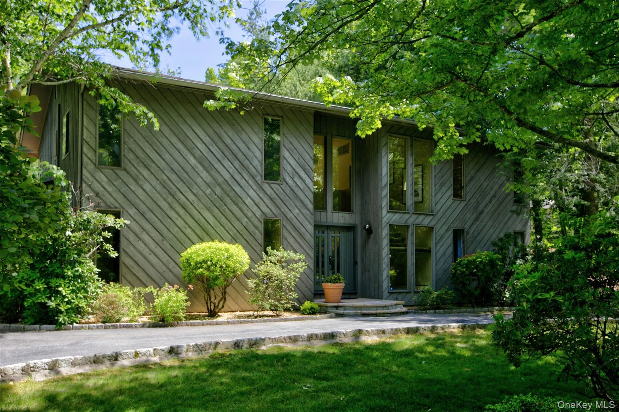 Mature, lush landscaping provides a serene natural backdrop while maintaining a polished, manicured aesthetic. Mature, lush landscaping provides a serene natural backdrop while maintaining a polished, manicured aesthetic.