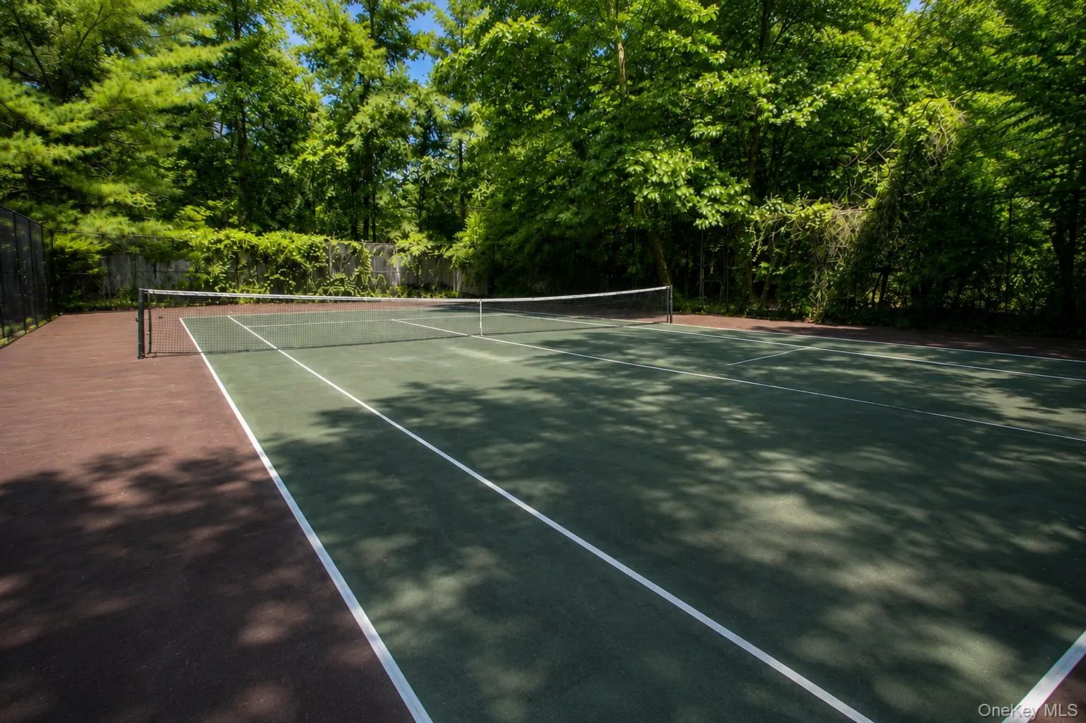 Virtually enhanced image. This AI-generated rendering is intended to illustrate the potential appearance of the Tennis Court following resurfacing and cosmetic improvements. Virtually enhanced image. This AI-generated rendering is intended to illustrate the potential appearance of the Tennis Court following resurfacing and cosmetic improvements.
