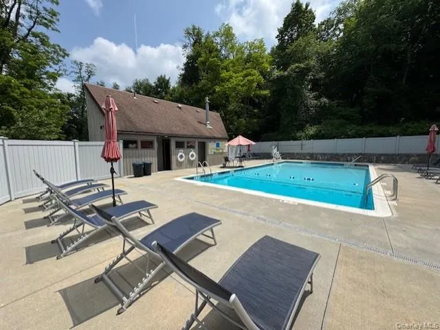 Community pool with a patio area Community pool with a patio area
