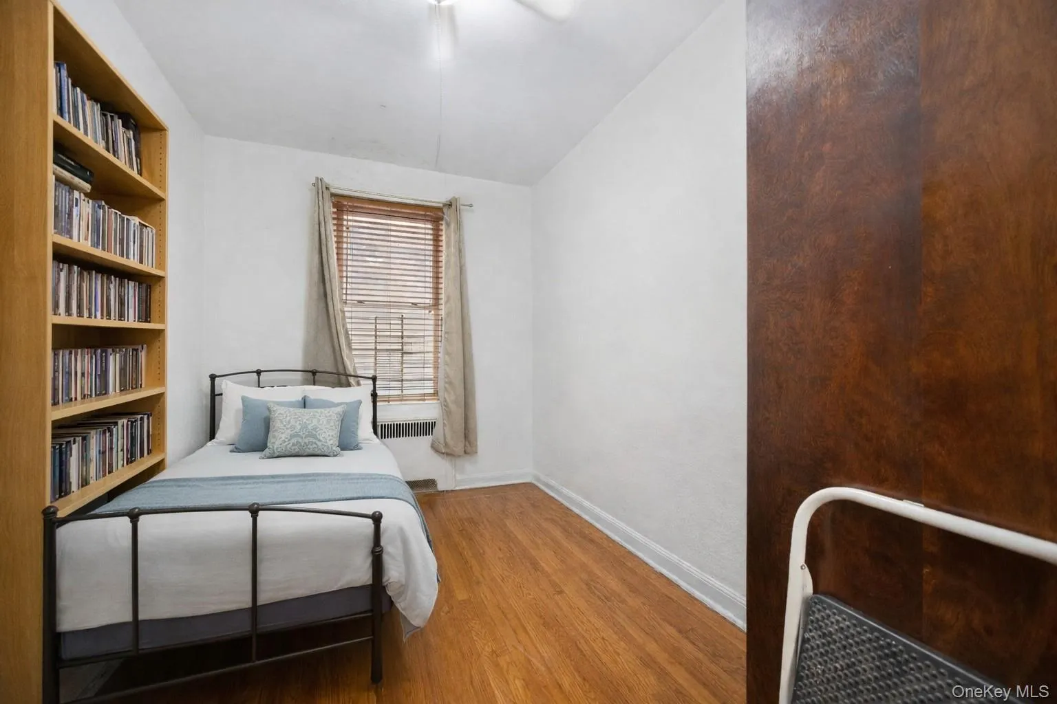 SECOND Bedroom with light wood-type flooring, radiator heating unit, and a ceiling fan SECOND Bedroom with light wood-type flooring, radiator heating unit, and a ceiling fan