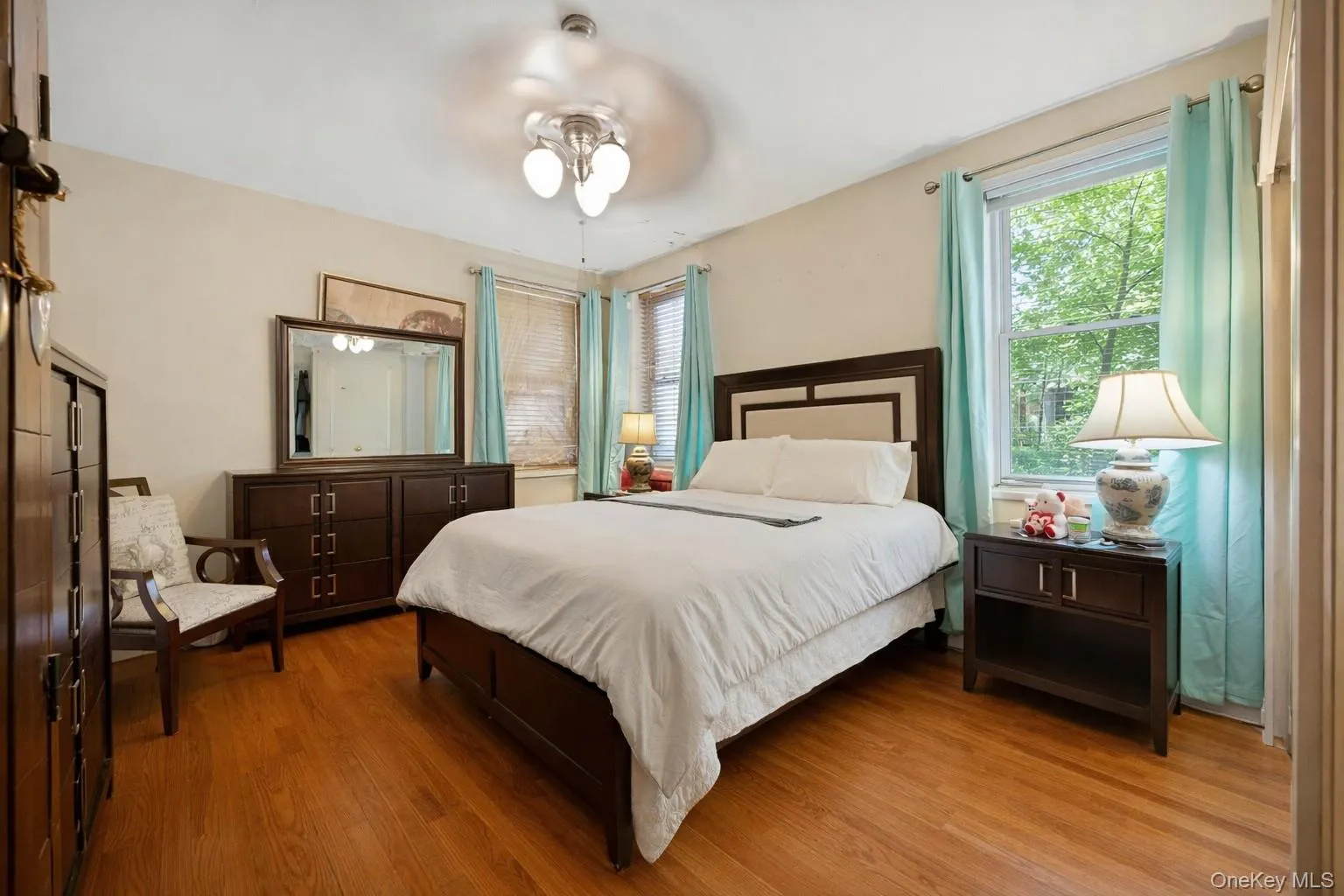 Bedroom featuring light wood finished floors and ceiling fan Bedroom featuring light wood finished floors and ceiling fan