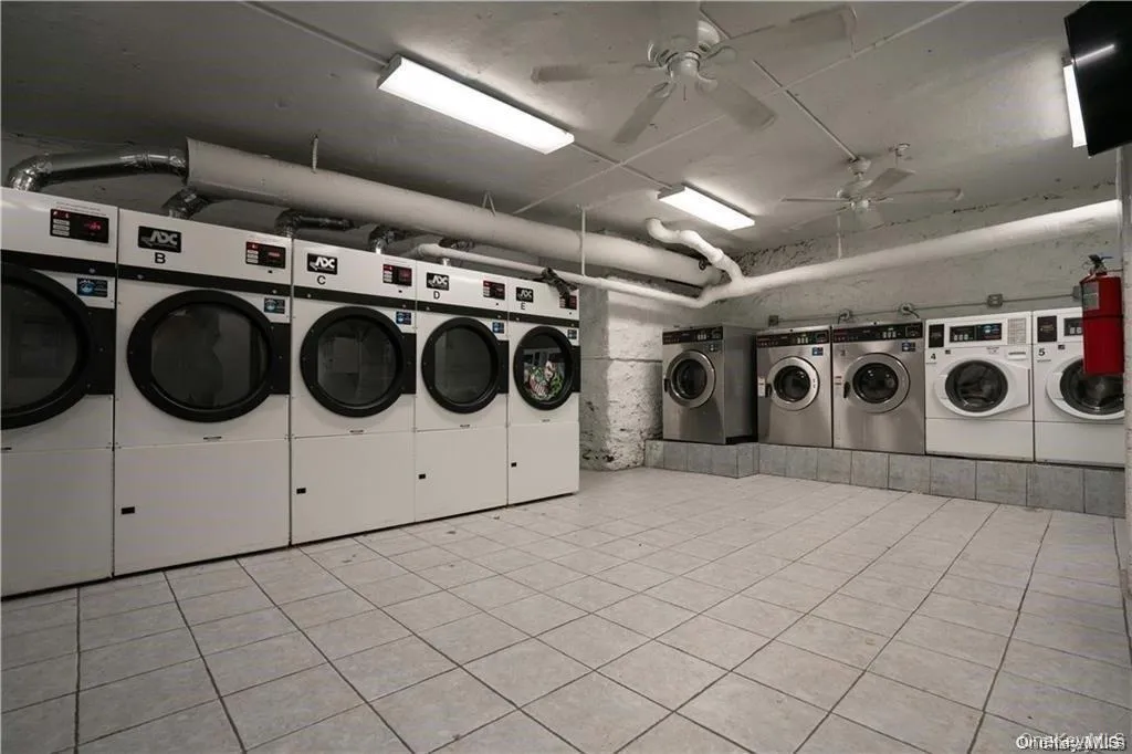 Shared laundry room with ceiling fan and independent washer and dryer Shared laundry room with ceiling fan and independent washer and dryer