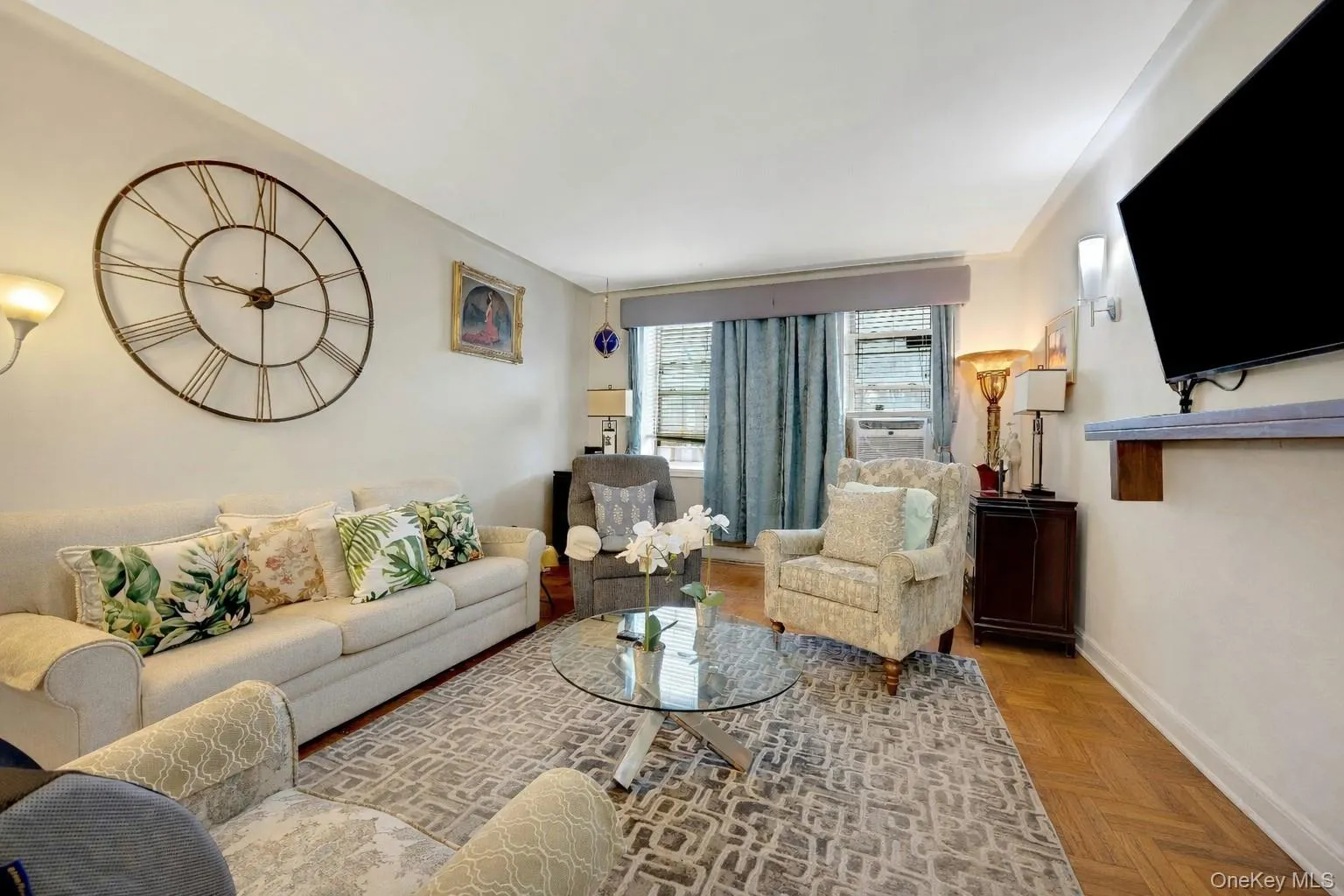 Living room with parquet flooring and baseboards Living room with parquet flooring and baseboards
