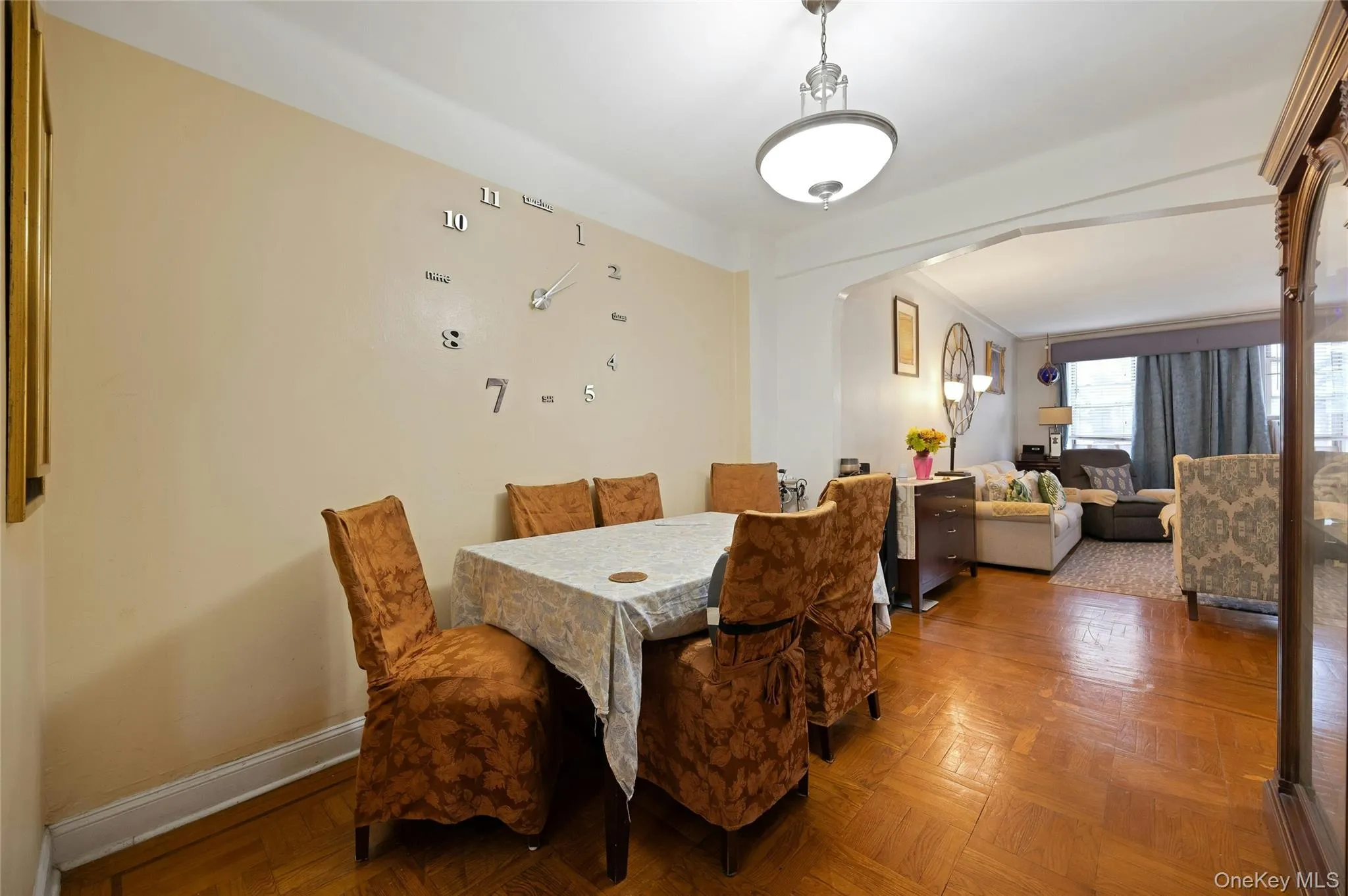 Dining room featuring arched walkways and parquet flooring Dining room featuring arched walkways and parquet flooring