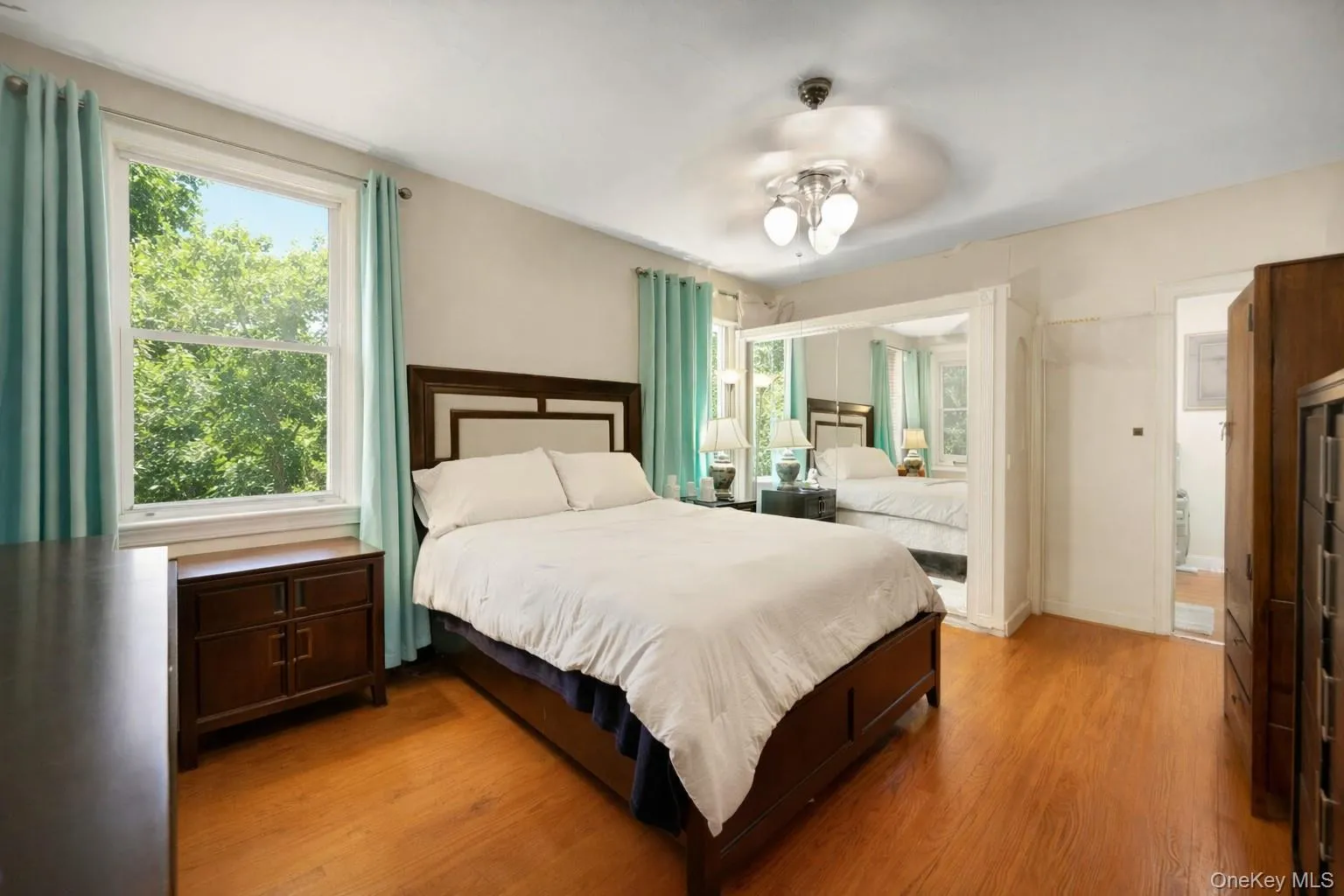 Bedroom with wood finished floors and ceiling fan Bedroom with wood finished floors and ceiling fan