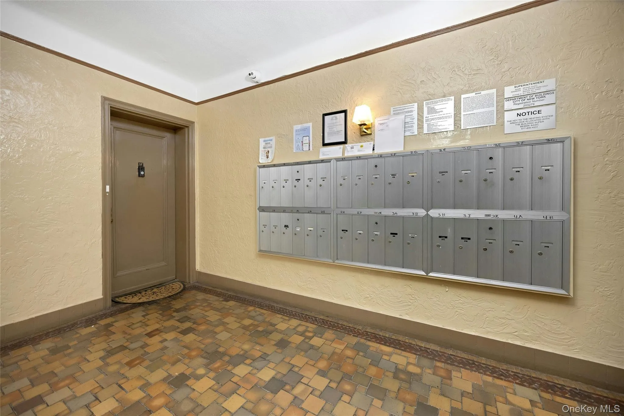 View of community with a textured wall and mail area View of community with a textured wall and mail area