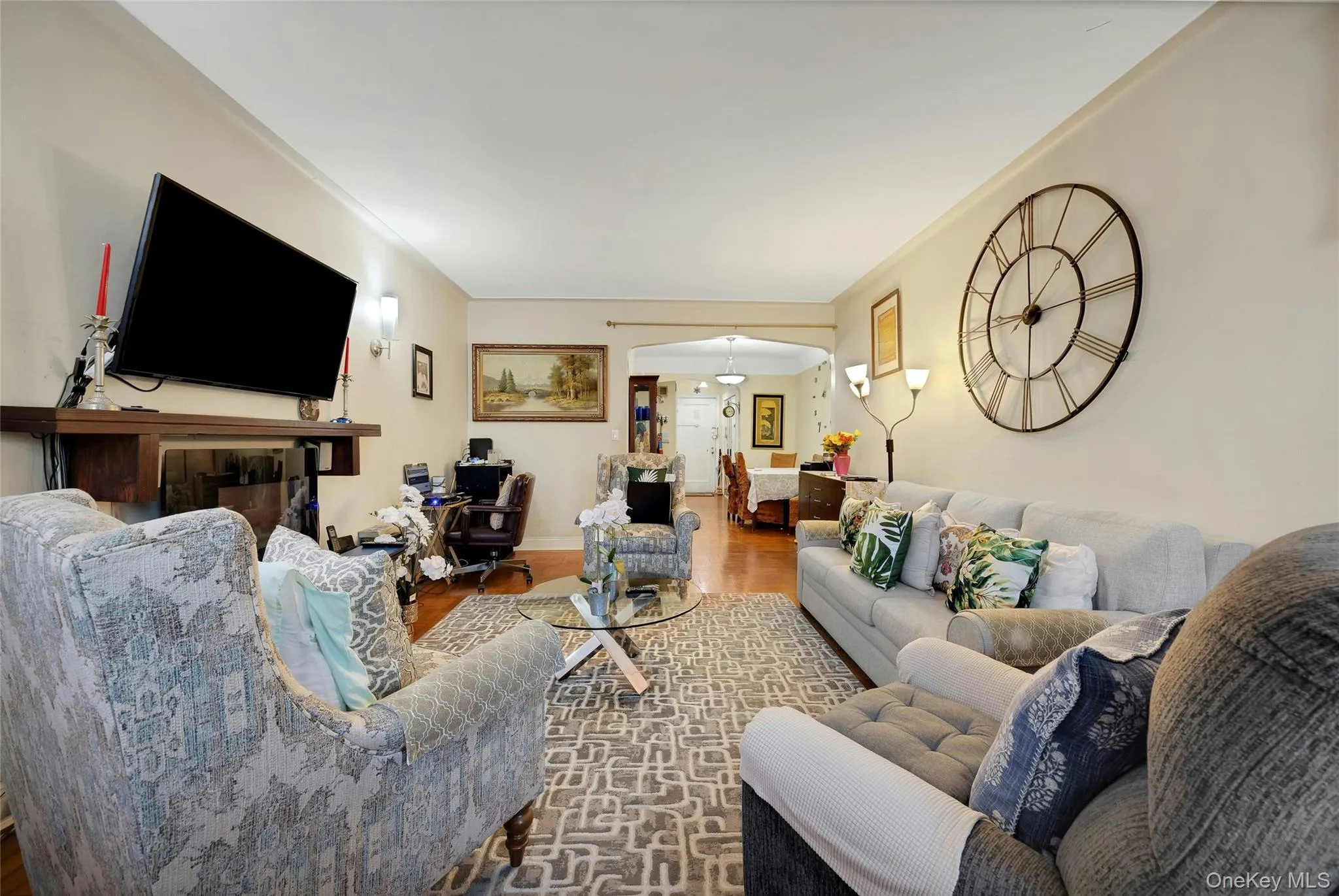 Living room with wood finished floors and arched walkways Living room with wood finished floors and arched walkways