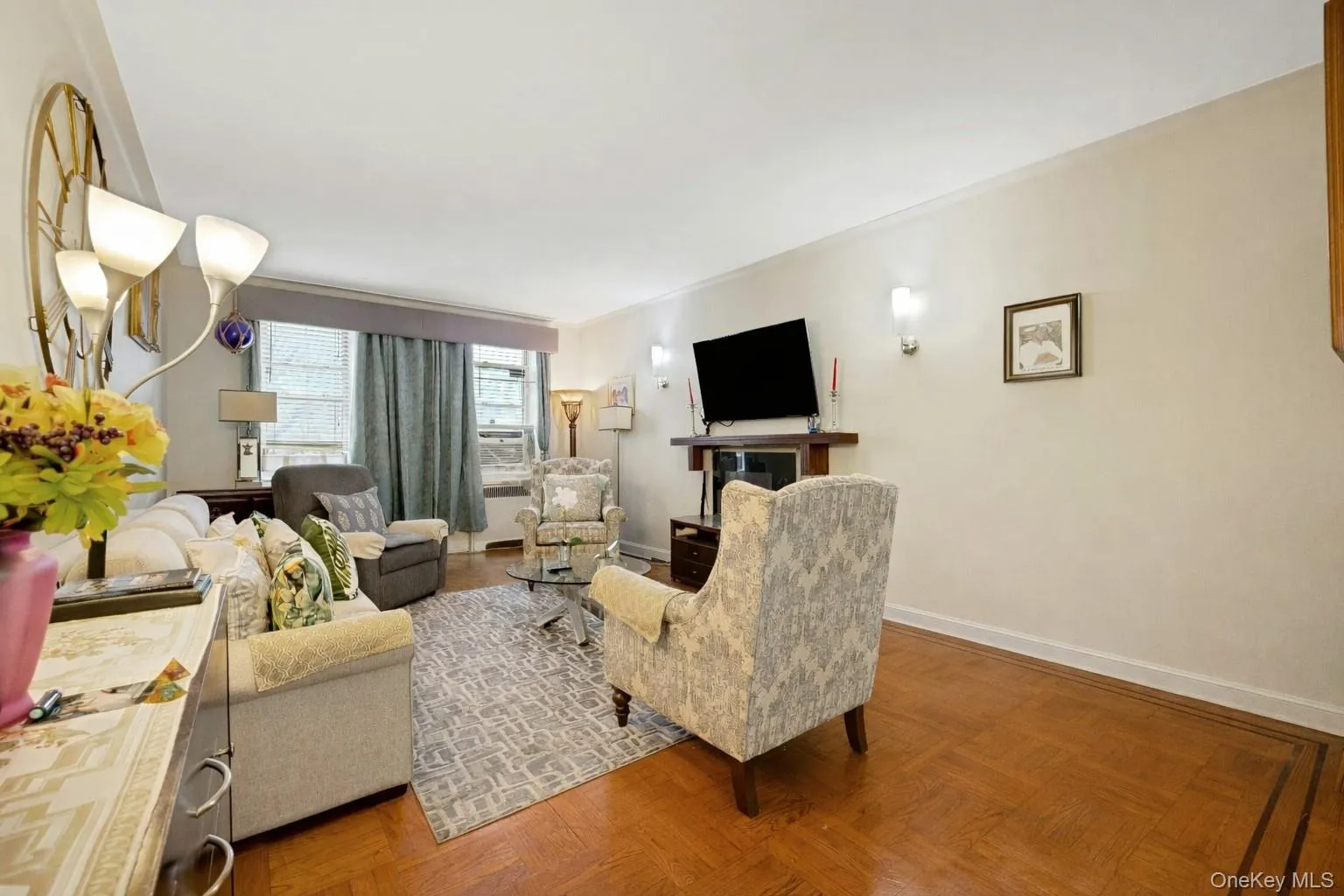 Living area with parquet flooring and baseboards Living area with parquet flooring and baseboards