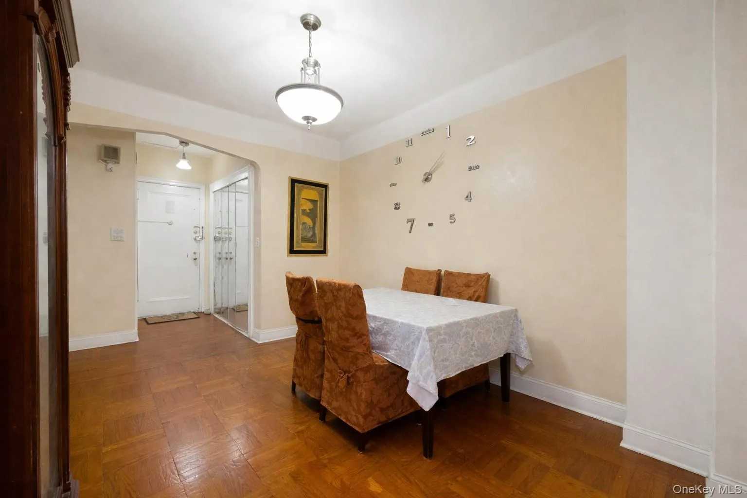 Dining room featuring arched walkways and parquet flooring Dining room featuring arched walkways and parquet flooring