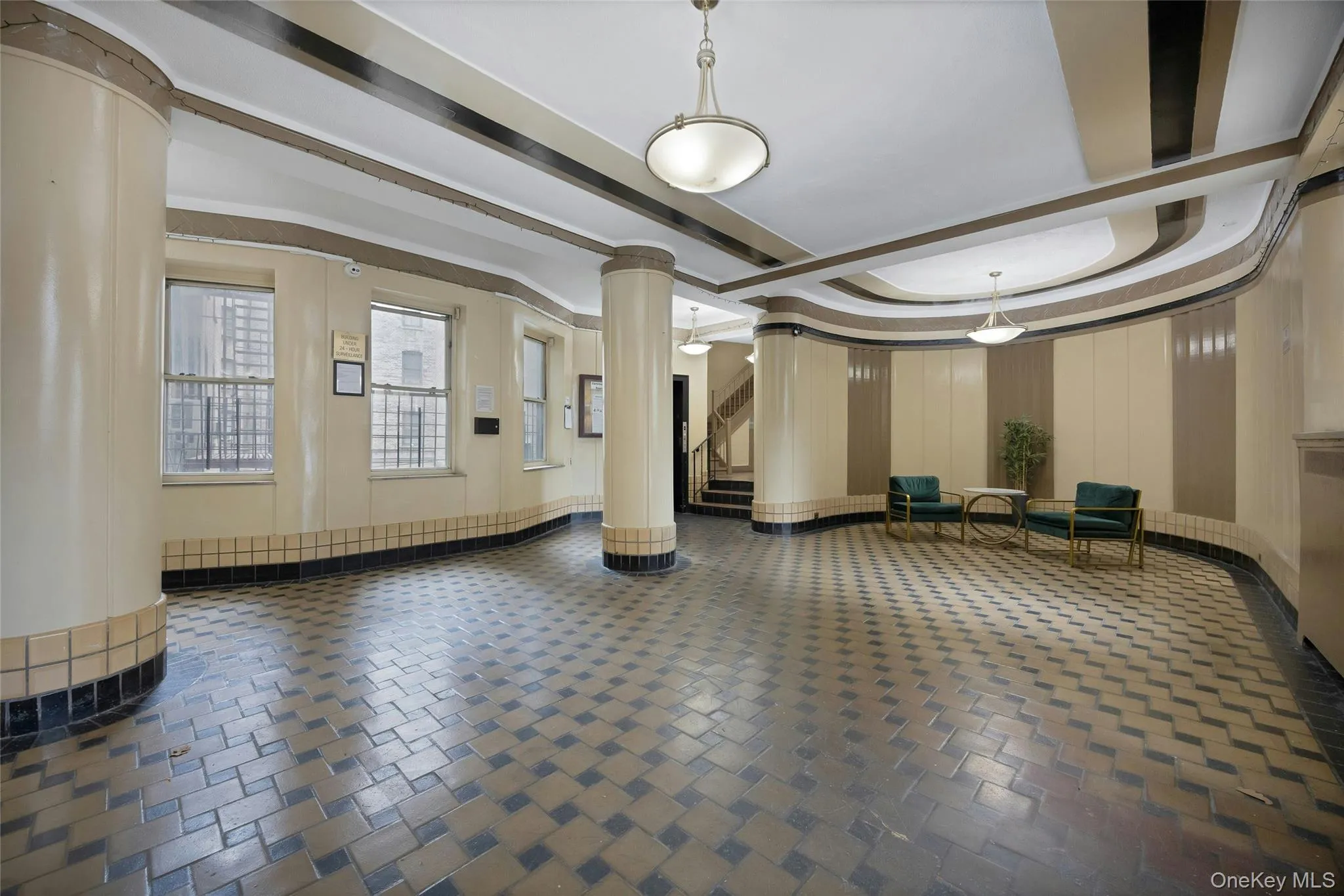 Common area featuring stairway and a raised ceiling Common area featuring stairway and a raised ceiling