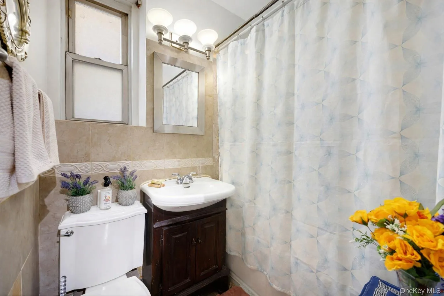 Full bath featuring vanity and tile walls Full bath featuring vanity and tile walls