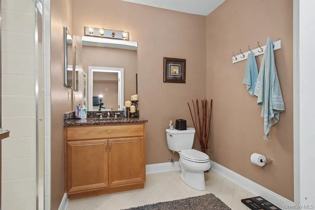 Bathroom on lower level has sink with vanity and stall shower Bathroom on lower level has sink with vanity and stall shower
