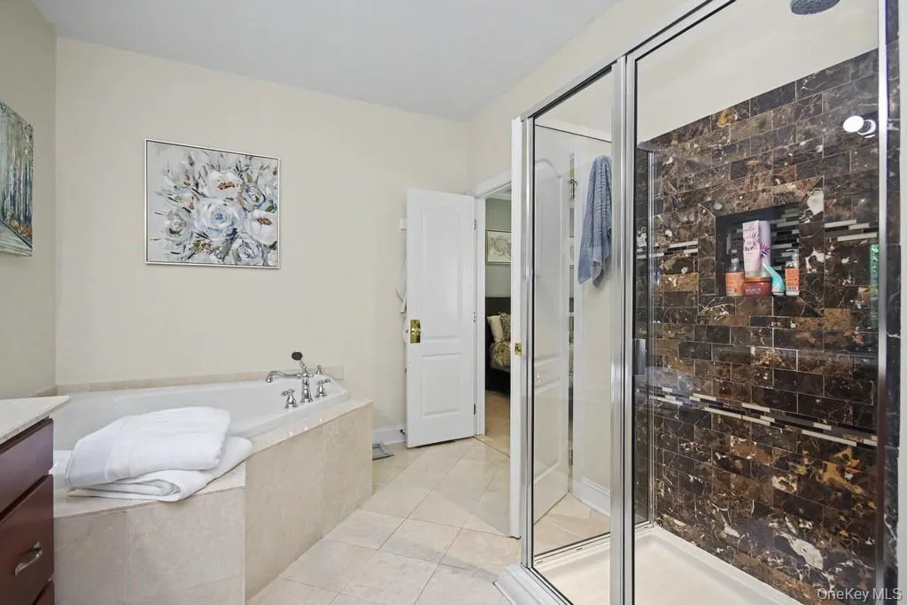 Stall shower and bathtub with whirlpool in Primary Bathroom Stall shower and bathtub with whirlpool in Primary Bathroom